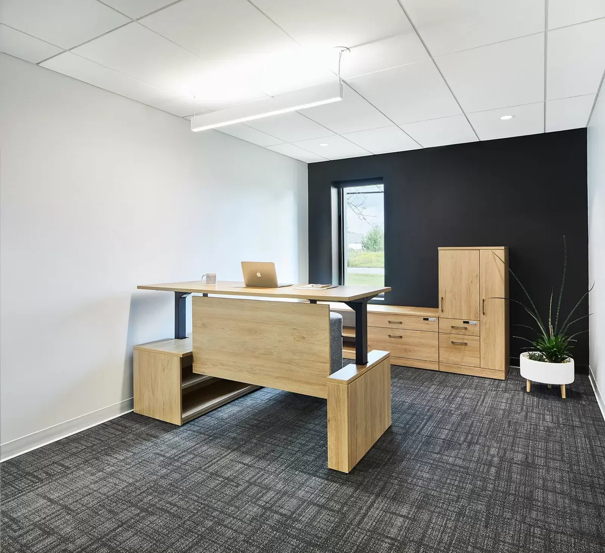 Height-adjustable desks in an office workspace