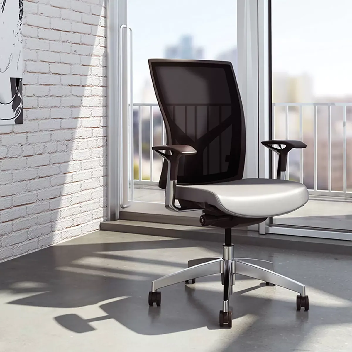 Black mesh office chair beside a window